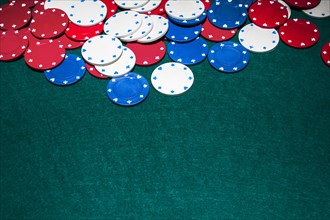 White blue red casino chips green background