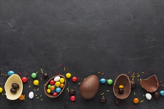 Top view chocolate easter eggs filled with colorful candy