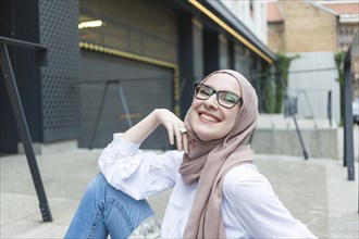 Woman with glasses hijab smiling