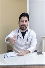 Latin doctor sitting at his desk