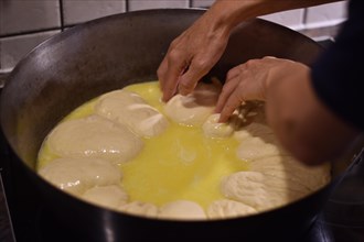 Preparation of steam noodles in rustic old steam noodle pan with lots of butter