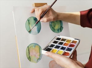 Young artist painting with watercolors