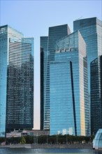 Group of buildings in CBD or Central Business District buildings over Marina Bay waters in day light