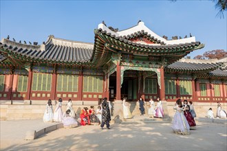 Young woman in traditional Hanbok dresses pose and take photographs