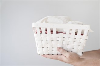 Sideways person holding laundry basket