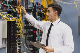 Young business engineer with tablet medium shot