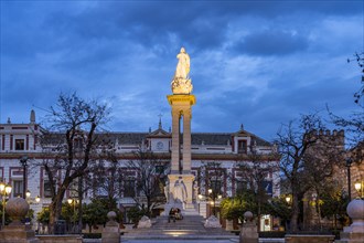 Inmaculada statue in the Plaza del Triunfo square at dusk