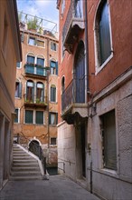 Old narrow streets or calles and bridges over waterways or rios of Venice