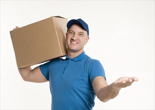 Front view delivery man carrying cardboard box