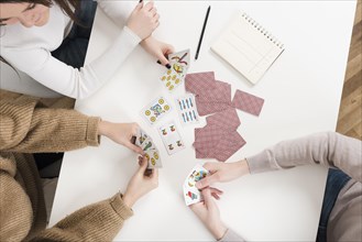 Top view friends playing cards game