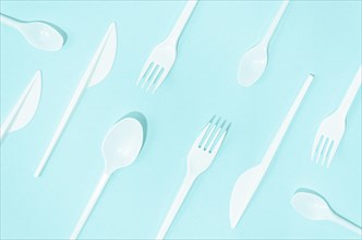 White disposable cutlery composition turquoise background
