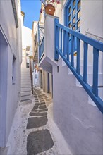 Charming traditional narrow streets and beautiful alleyways of Greek island towns. Whitewashed houses