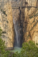 Suspension bridge and waterfall of the via ferrata Caminito del Rey near El Chorro