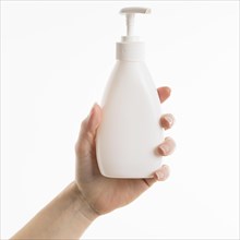 Hand holding liquid soap bottle
