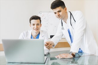 Doctors looking laptop