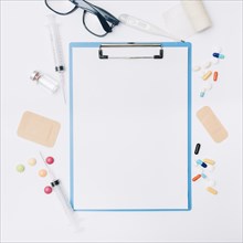 Glasses medications around clipboard