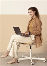 Young businesswoman working indoors from laptop
