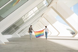 Lgbt couple holding rainbow flag