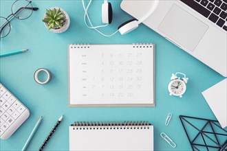 Flat lay desk calendar blue background
