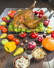 Roasted turkey with vegetables wooden table
