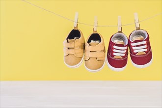 Newborn concept with two shoes clothesline