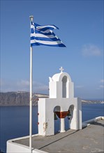 Whitewashed belfry and Greek national flag