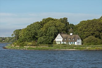 Thatched roof house on the shore