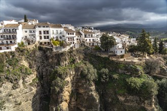 The white houses of the old town La Ciudad on a rocky plateau above the gorge Tajo de Ronda