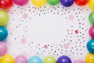 Colorful balloons border with confetti props white background