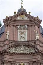 The historic facade with sculptures Neumuenster Catholic Church also Neumuenster St John the Evangelist and St John the Baptist