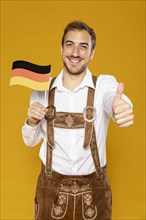 Front view man holding german flag
