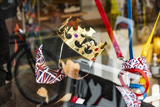 Toy dog with crown and Union Jack neckerchief in a shop window in Brighton
