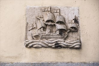 Relief of a sailing ship on a house wall in Lisbon
