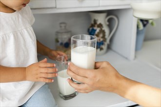 Mother hand offering glass milk