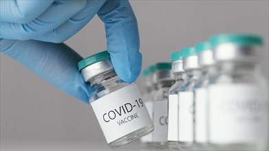 Doctor holding covid 19 vaccine bottle