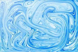 Style ebru painting with blue acrylic paint swirls