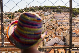 A person looks out over the old town of Lisbon