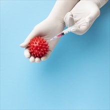 Top view hand holding virus syringe with vaccine