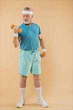 Modern senior man training with dumbbells