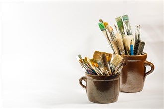 Artistic brushes and painting tools in old clay