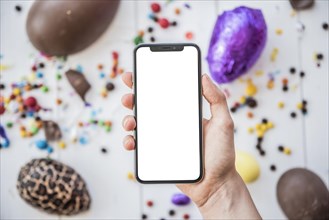 Person holding smartphone with blank screen easter eggs