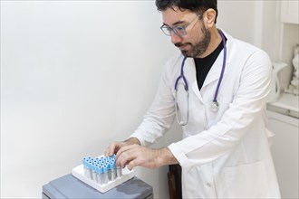 Latin Doctor holds laboratory samples