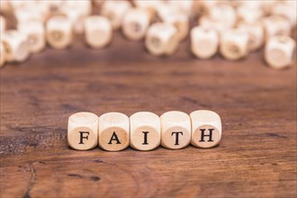 Wooden cubes with word faith table