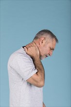 Side view mature man suffering from neck pain