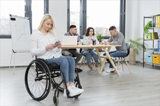 Woman wheelchair working from her phone office