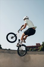 Young man extreme jumping with bicycle