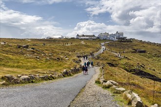 Walkers on headland Land's End