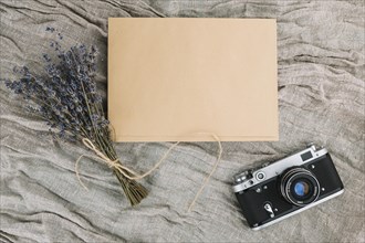 Camera with blank paper violet bouquet