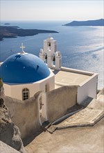 Iconic blue-domed church and Three-bells of Fira belfry with sea view