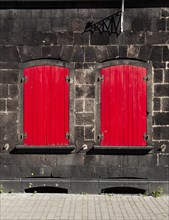 Closed red shutters on a house in Andernach